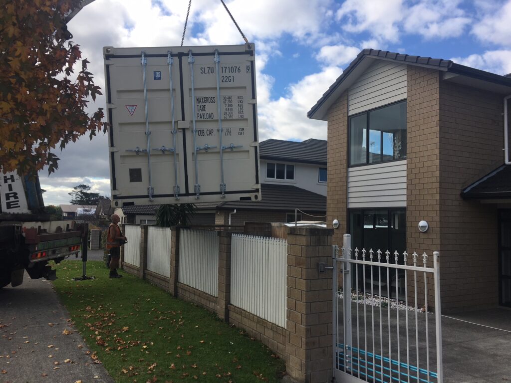 20FT Container being lifted over a fence