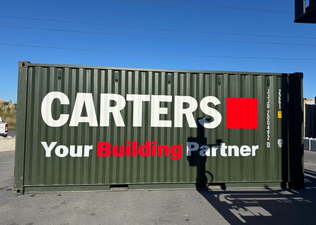 Green shipping container branded with Carters