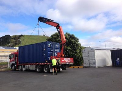 HIAB truck delivering a shipping container to a customer site.