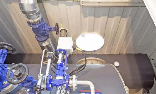Pipework and tank inside modified shipping container plant room