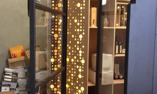 Interior shelving and illuminated feature panel inside modified wine storage container