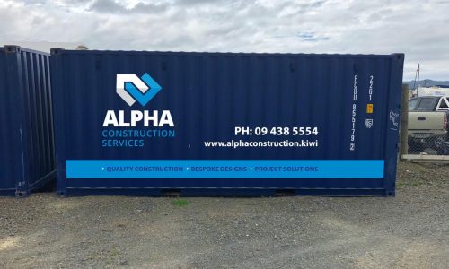Blue shipping container branded with Alpha Construction Services